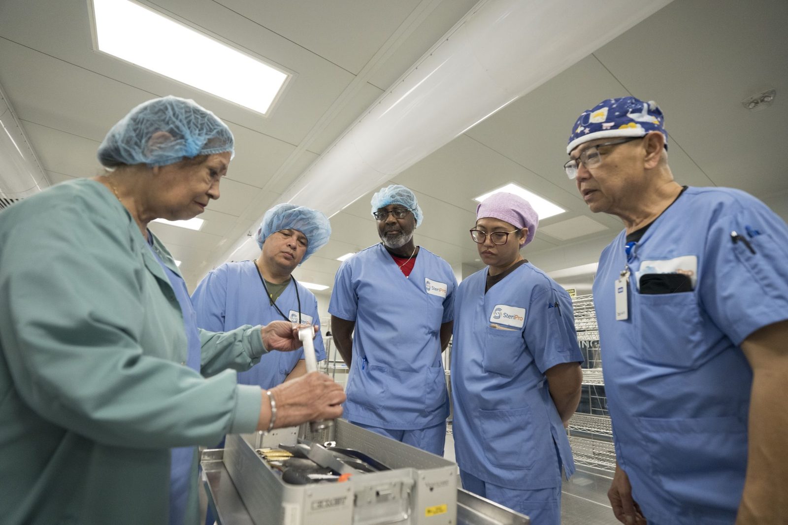 SteriPro Academy educator demonstrating instrument handling to a group of technicians