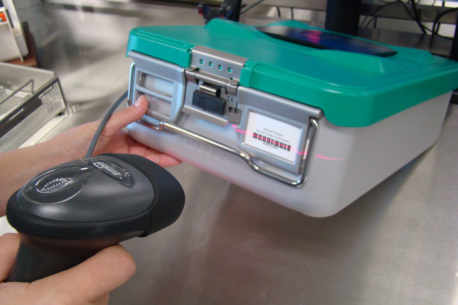 Technician scanning an instrument container barcode into the STS tracking system