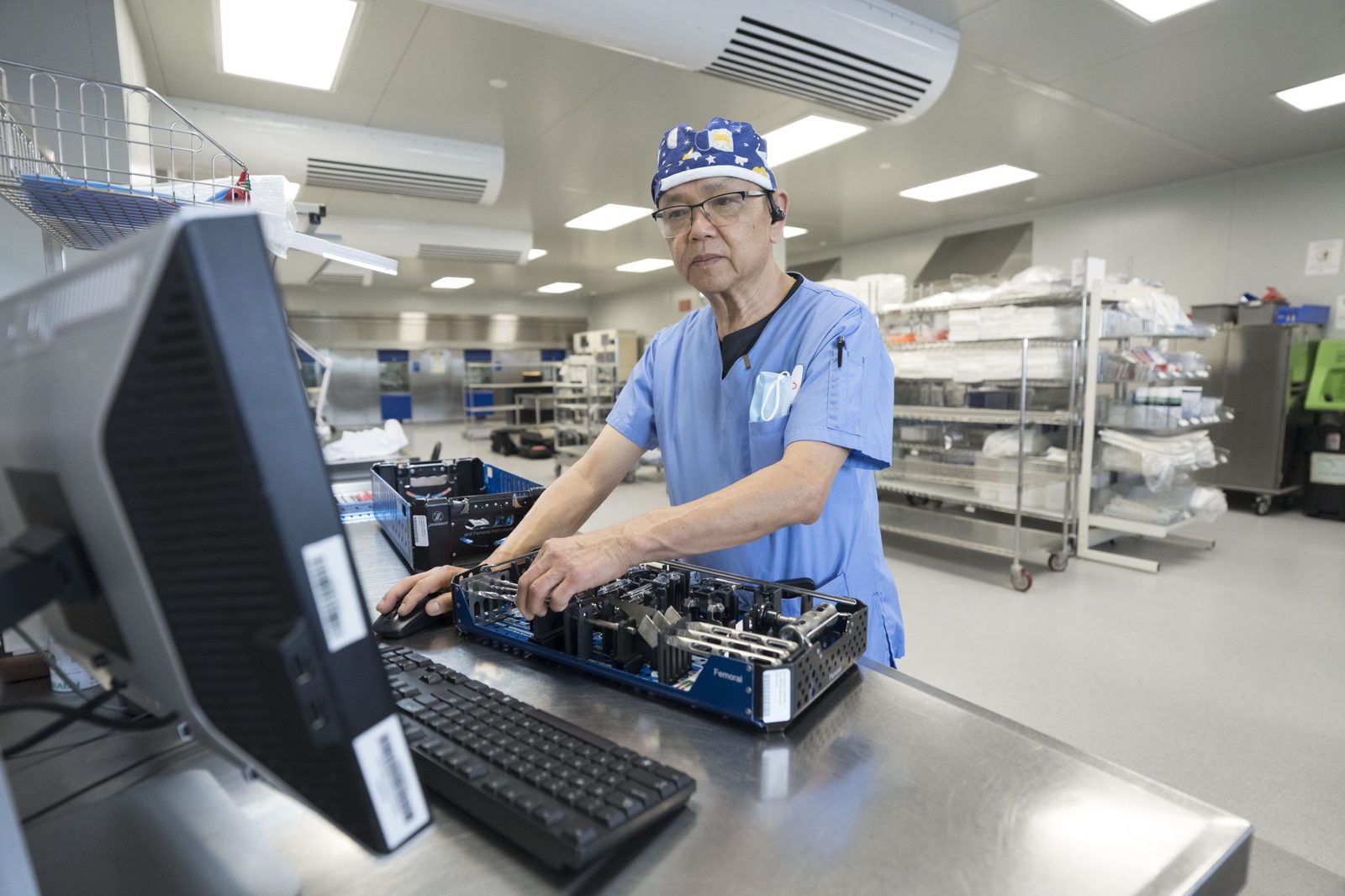 SteriPro technician recording instrument data at an STS tracking workstation